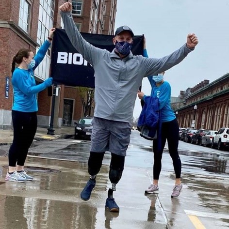 A triumphant runner with two leg prostheses.