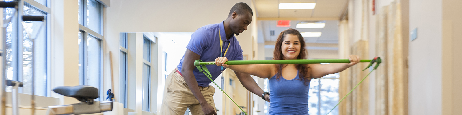 Rehabilitation Assistant Clarence Tuning works with a wounded soldier to rebuild his muscles.