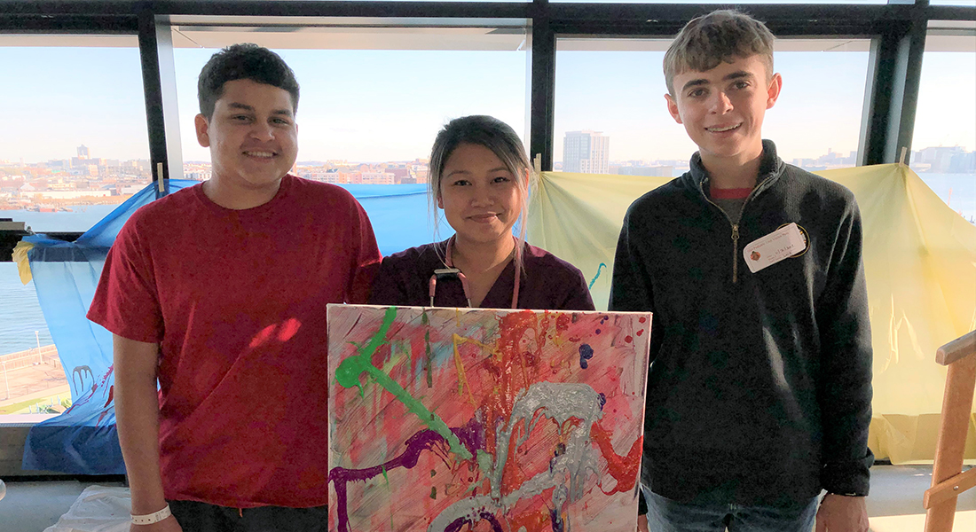 Now a healthy teenager, Braiden (far right) and his dad hosted a syringe art auction in 2019 to bene