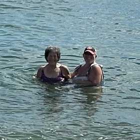 Kathy and her daughter swimming in the sea.