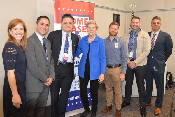 Group photo of members of Home Base Program with Senator Warren