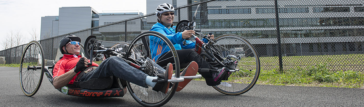 man and woman riding adaptive bike