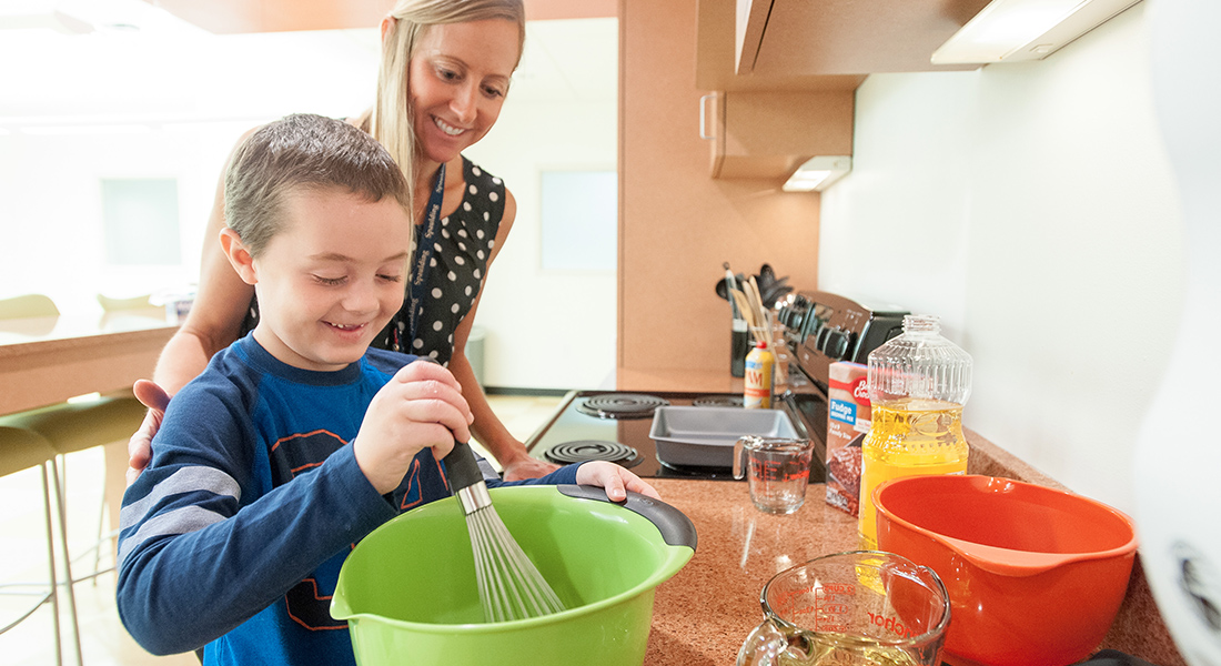 Pediatric patient physical therapist in kitchen