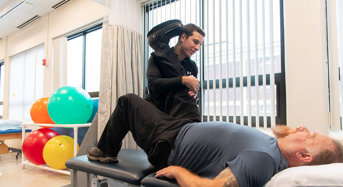 Physical therapist stetching patient's leg at Spaulding Outpatient Center Salem