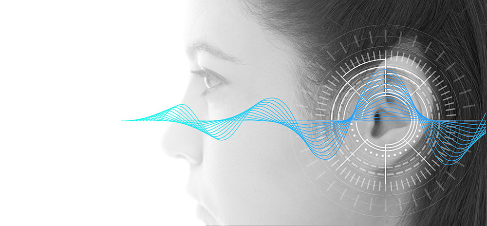 Woman's head with a sound wave and data dial graphic centered on the ear.