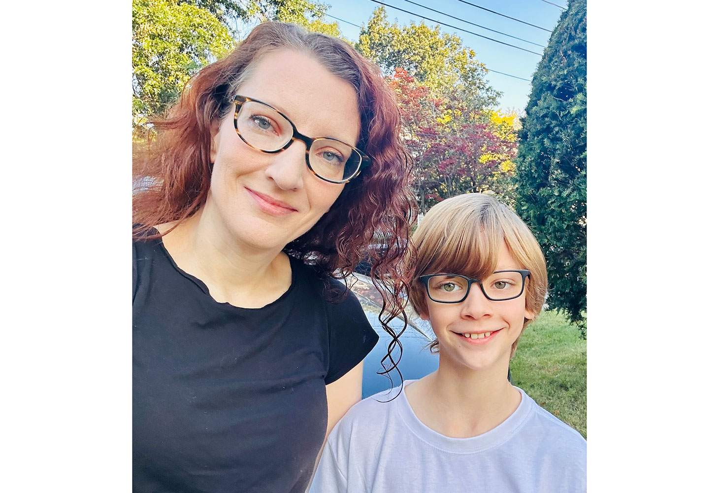 Branwen and her son smiling in their yard.