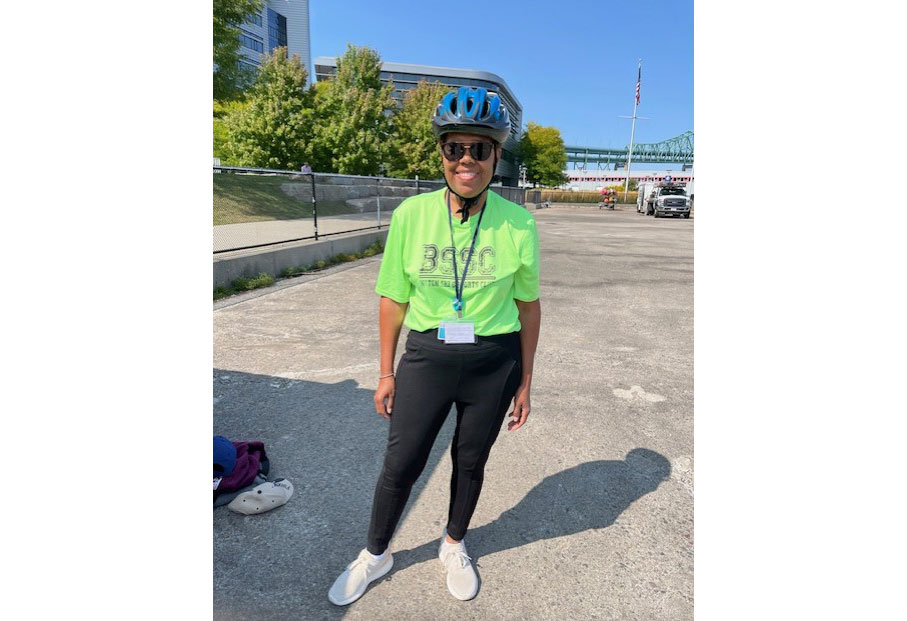 Donna, a fit woman in exercise clothes and a cycling helmet.